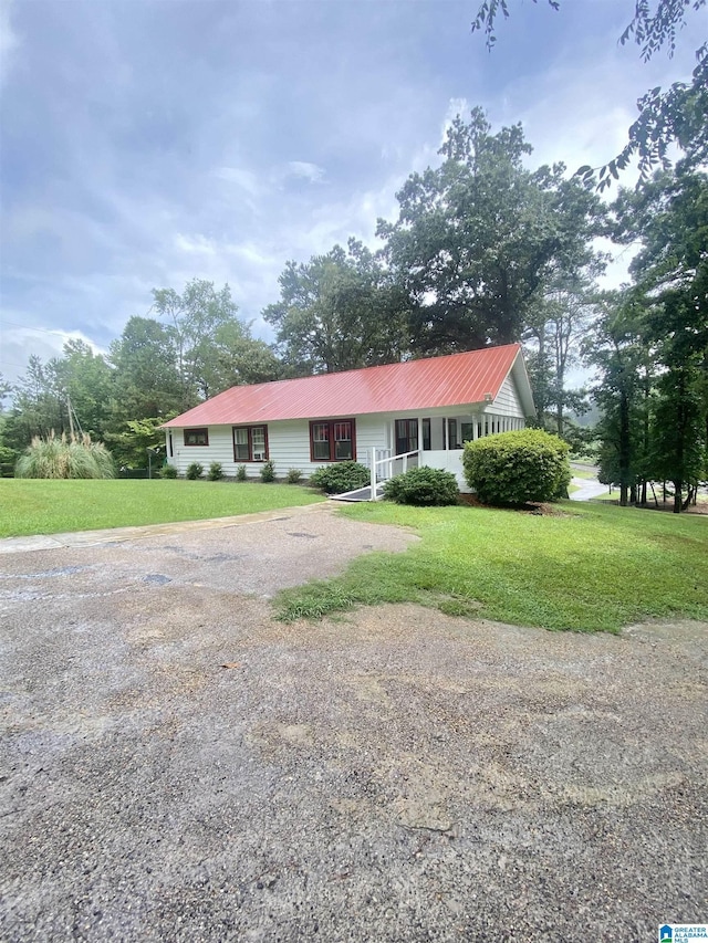 ranch-style home with a front lawn