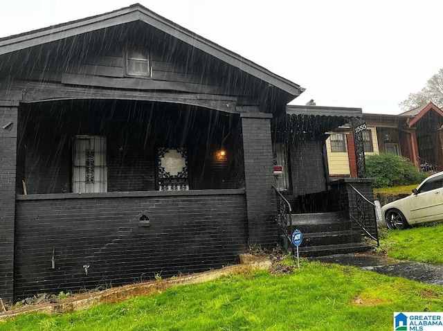 view of side of property with covered porch