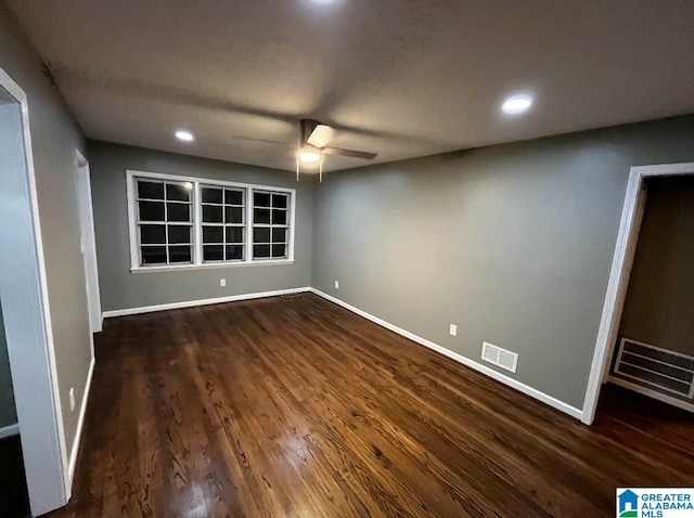 empty room featuring ceiling fan and dark wood-type flooring