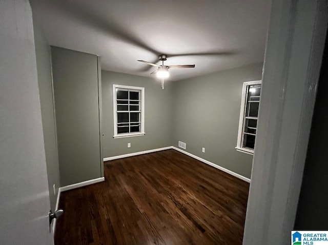 unfurnished room featuring dark hardwood / wood-style floors and ceiling fan