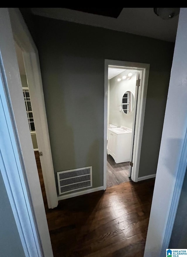 corridor with dark hardwood / wood-style floors