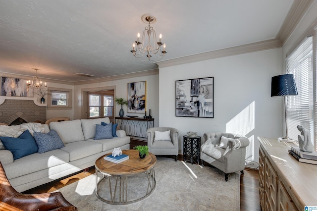 living room featuring a notable chandelier, a fireplace, and a wealth of natural light