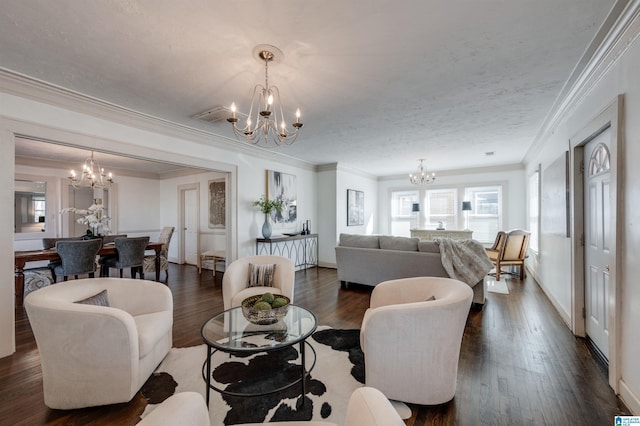 living room featuring a textured ceiling, dark hardwood / wood-style floors, an inviting chandelier, and crown molding