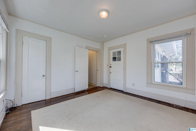 unfurnished bedroom with dark wood-type flooring