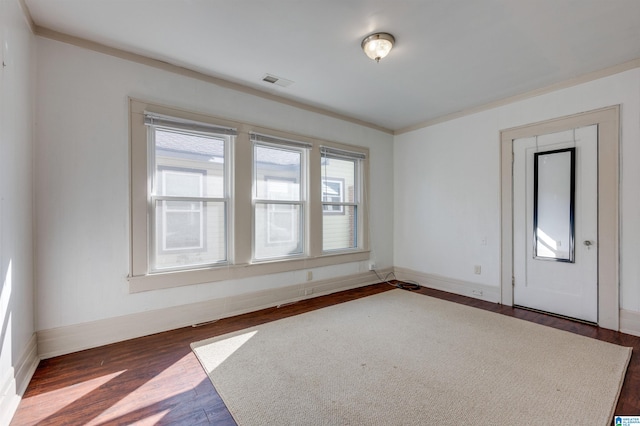 unfurnished room featuring dark hardwood / wood-style flooring and ornamental molding