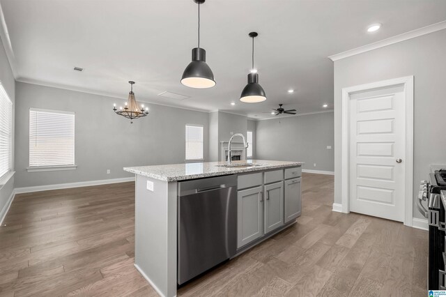 kitchen featuring gray cabinetry, ceiling fan with notable chandelier, stainless steel appliances, sink, and a center island with sink