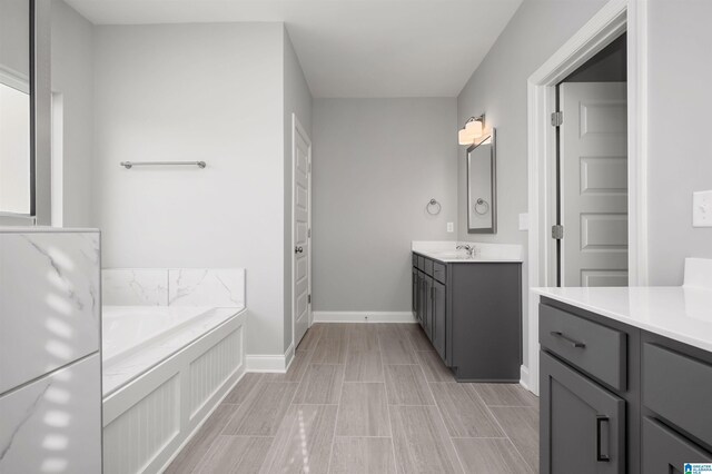 bathroom with vanity and a tub