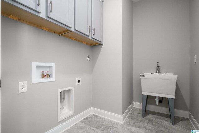 laundry room with electric dryer hookup, cabinets, and washer hookup