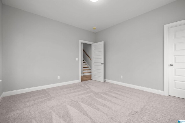 unfurnished bedroom featuring light carpet