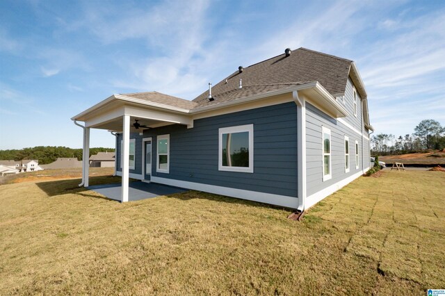 rear view of property with a lawn and a patio