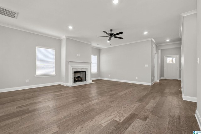 unfurnished living room with a fireplace, dark wood-type flooring, ceiling fan, and ornamental molding