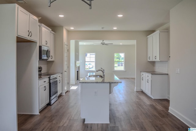 kitchen featuring white cabinetry, an island with sink, and stainless steel appliances