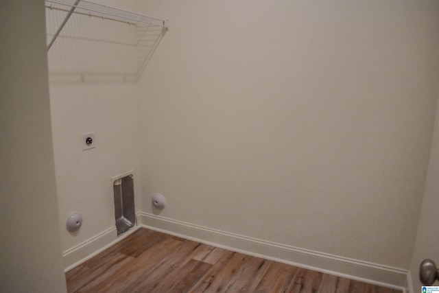 laundry area with electric dryer hookup and wood-type flooring