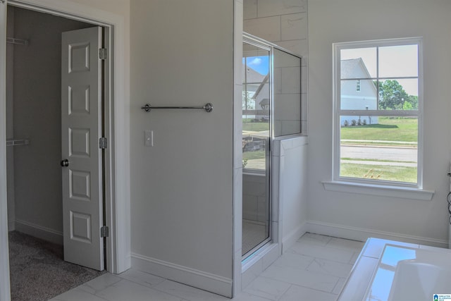 bathroom featuring plenty of natural light and walk in shower