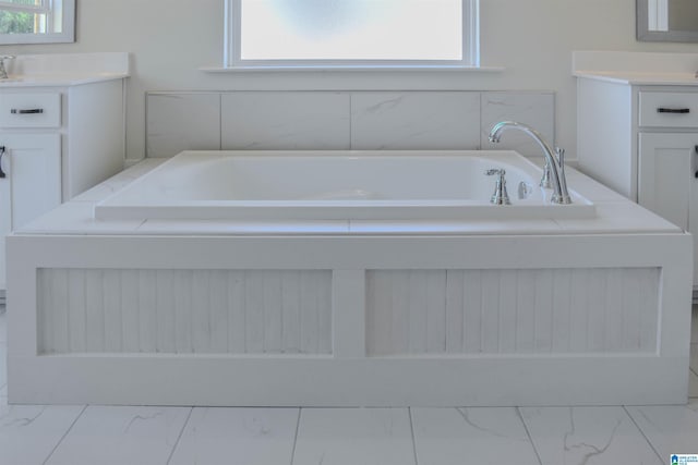 bathroom featuring vanity and a bath