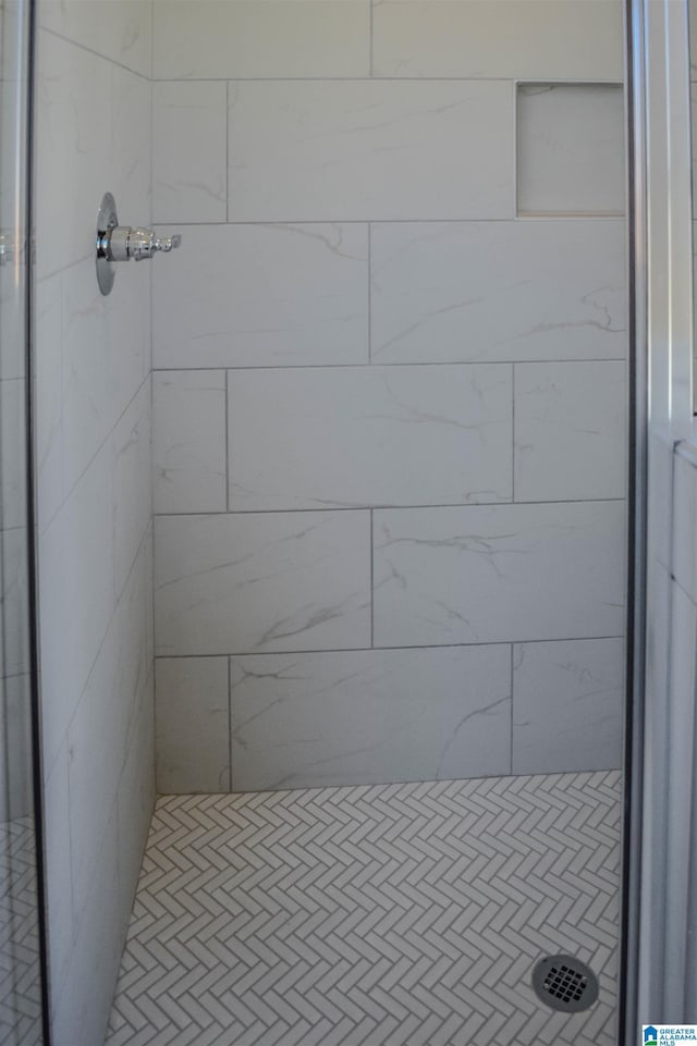 bathroom with a tile shower