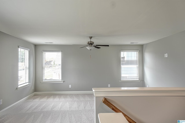 empty room featuring light carpet and ceiling fan