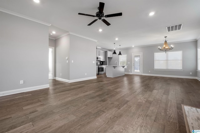 unfurnished living room with ceiling fan with notable chandelier, dark hardwood / wood-style floors, and ornamental molding