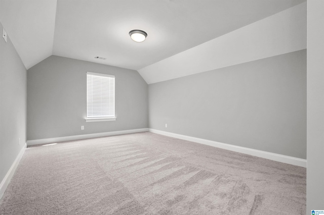 bonus room with carpet and vaulted ceiling