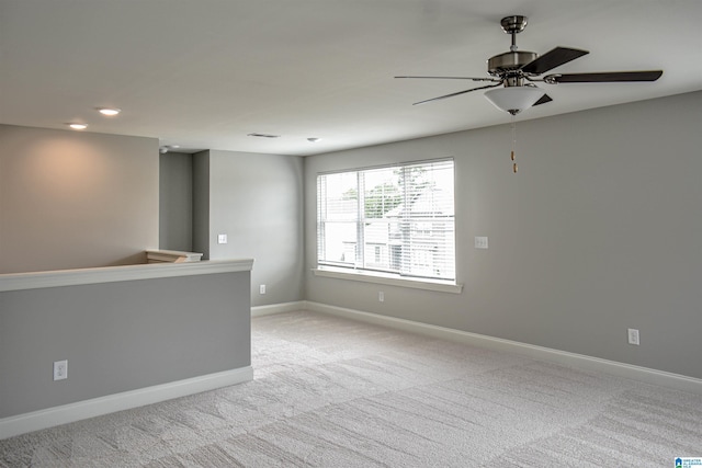 carpeted spare room with ceiling fan