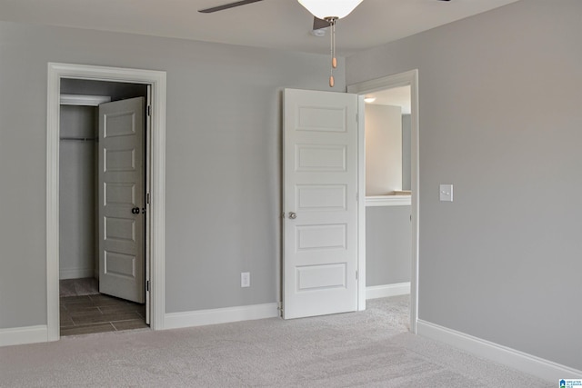 unfurnished bedroom featuring carpet flooring, ceiling fan, and a closet