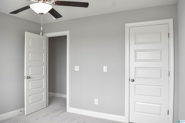 unfurnished bedroom featuring light colored carpet and ceiling fan