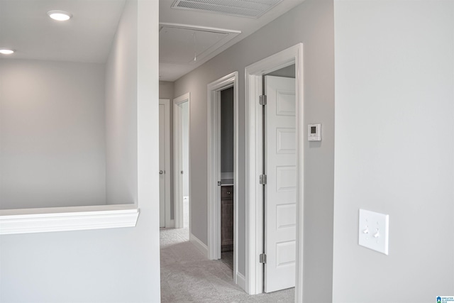 hallway featuring light colored carpet