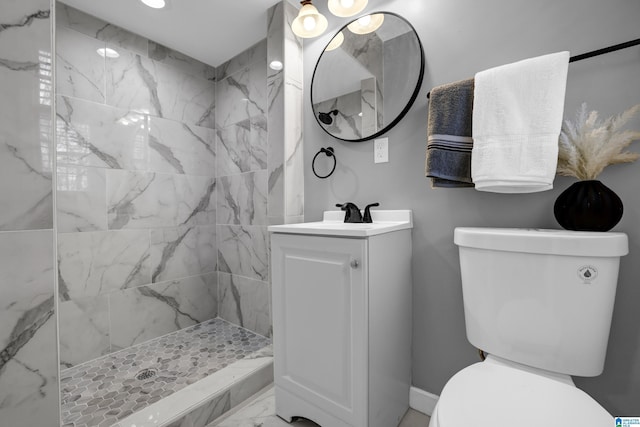 full bath with a stall shower, marble finish floor, vanity, and toilet