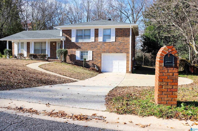 split level home with driveway, an attached garage, and brick siding