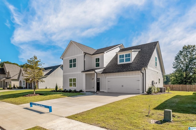 view of front of house with a front yard and a garage