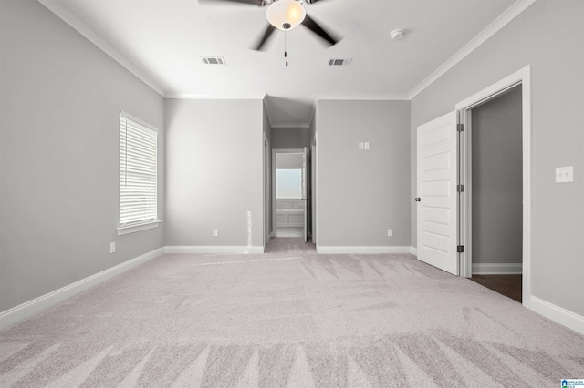 carpeted spare room with ceiling fan and crown molding