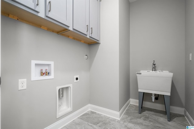 clothes washing area featuring cabinets, hookup for a washing machine, and electric dryer hookup