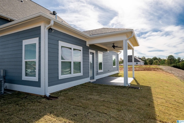 view of property exterior featuring a lawn, a patio area, and ceiling fan