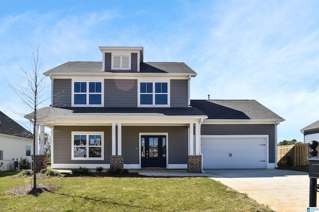 view of front facade featuring covered porch, a garage, and a front lawn