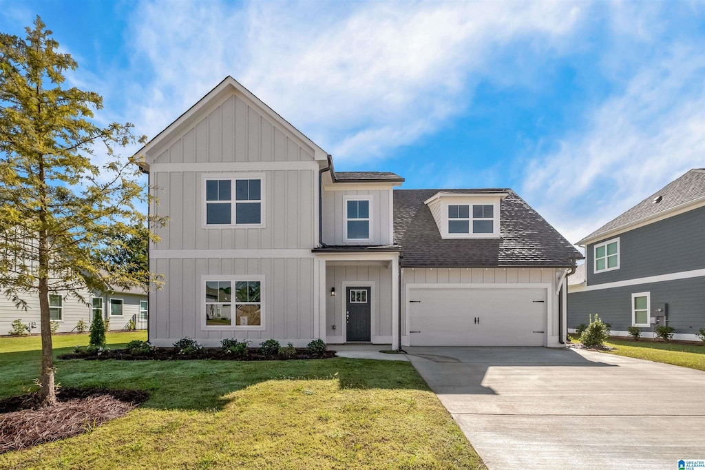 view of front of house with a garage and a front lawn