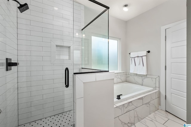 bathroom with a bath, marble finish floor, and a stall shower