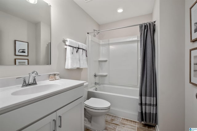 bathroom with toilet, vanity, and shower / bath combo with shower curtain