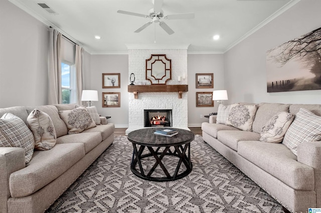 244 Avondale Ln, Pell City, AL 35128 - living room with crown molding, wood finished floors, ceiling fan, a fireplace, and recessed lighting