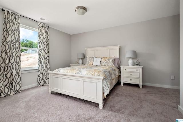 bedroom with baseboards, visible vents, and carpet floors