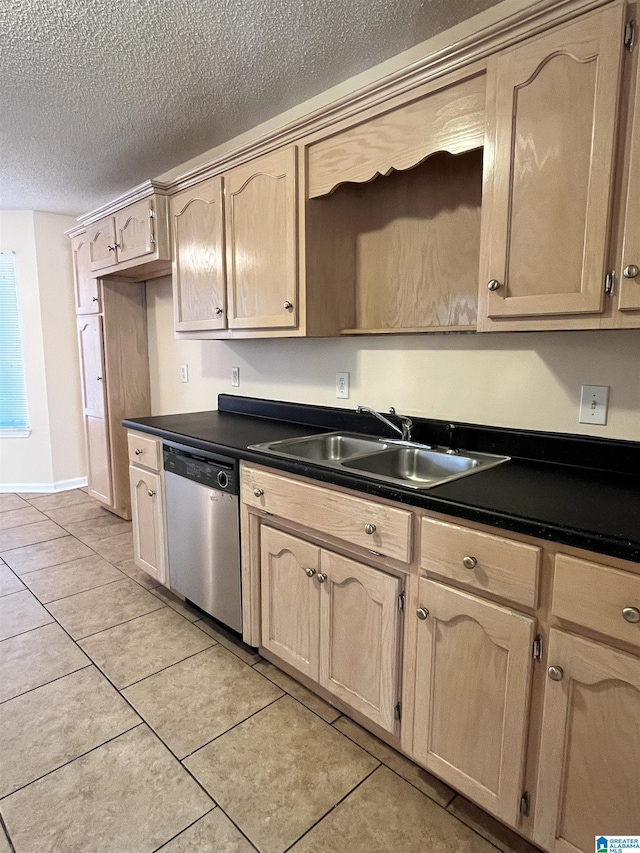 kitchen with sink, stainless steel dishwasher, light brown cabinetry, and light tile patterned floors