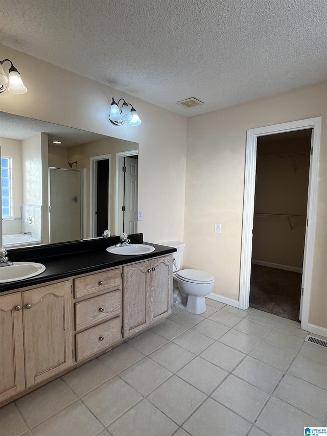 full bathroom featuring tile patterned flooring, vanity, separate shower and tub, and a textured ceiling