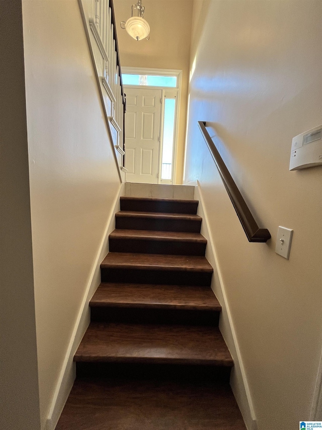 stairs featuring wood-type flooring