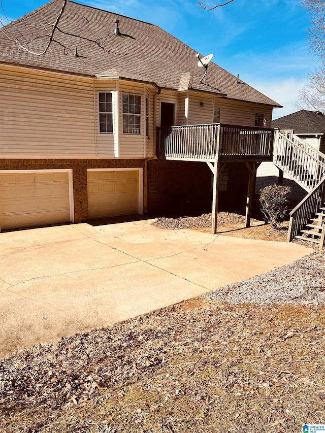 view of front of house with a garage and a deck