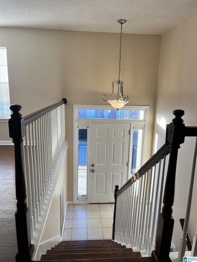 tiled entrance foyer with plenty of natural light and a textured ceiling