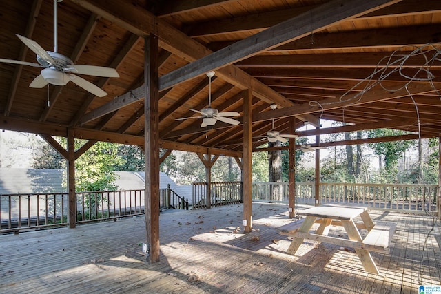 wooden terrace with a gazebo and ceiling fan