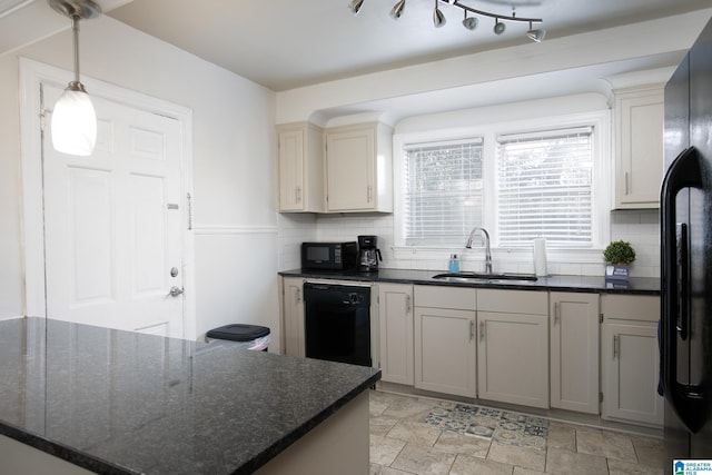 kitchen with pendant lighting, backsplash, dark stone counters, black appliances, and sink