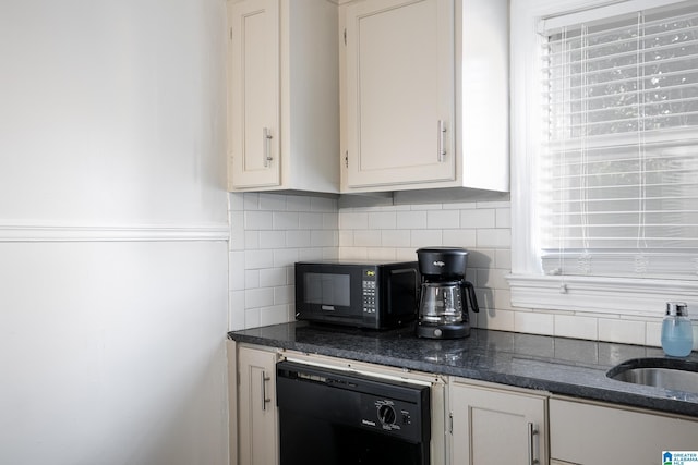 kitchen featuring sink, backsplash, dark stone counters, white cabinets, and black appliances