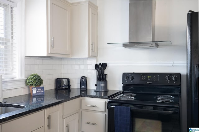 kitchen with white cabinets, decorative backsplash, wall chimney range hood, and black range with electric cooktop