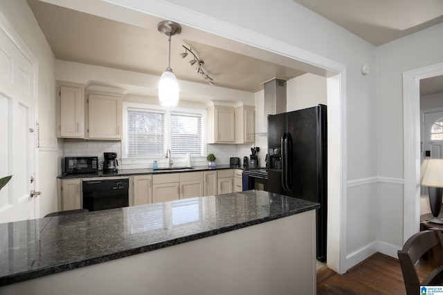 kitchen featuring sink, hanging light fixtures, tasteful backsplash, kitchen peninsula, and black appliances