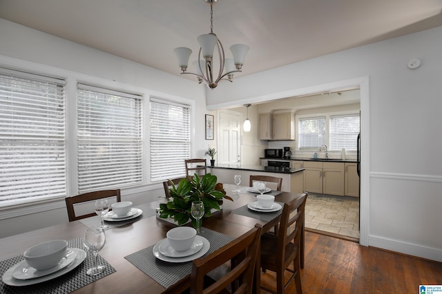 dining room with dark hardwood / wood-style flooring, sink, plenty of natural light, and a notable chandelier